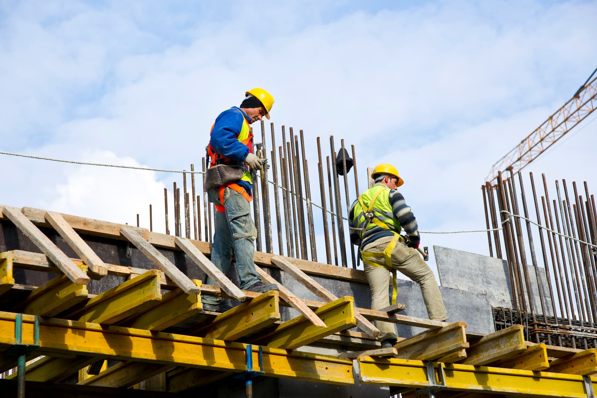 Industrial workers in safety gear viewing machinery